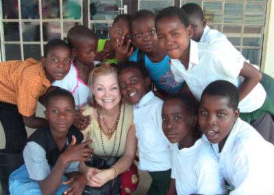Kathryn surrounded by young S.A. male students